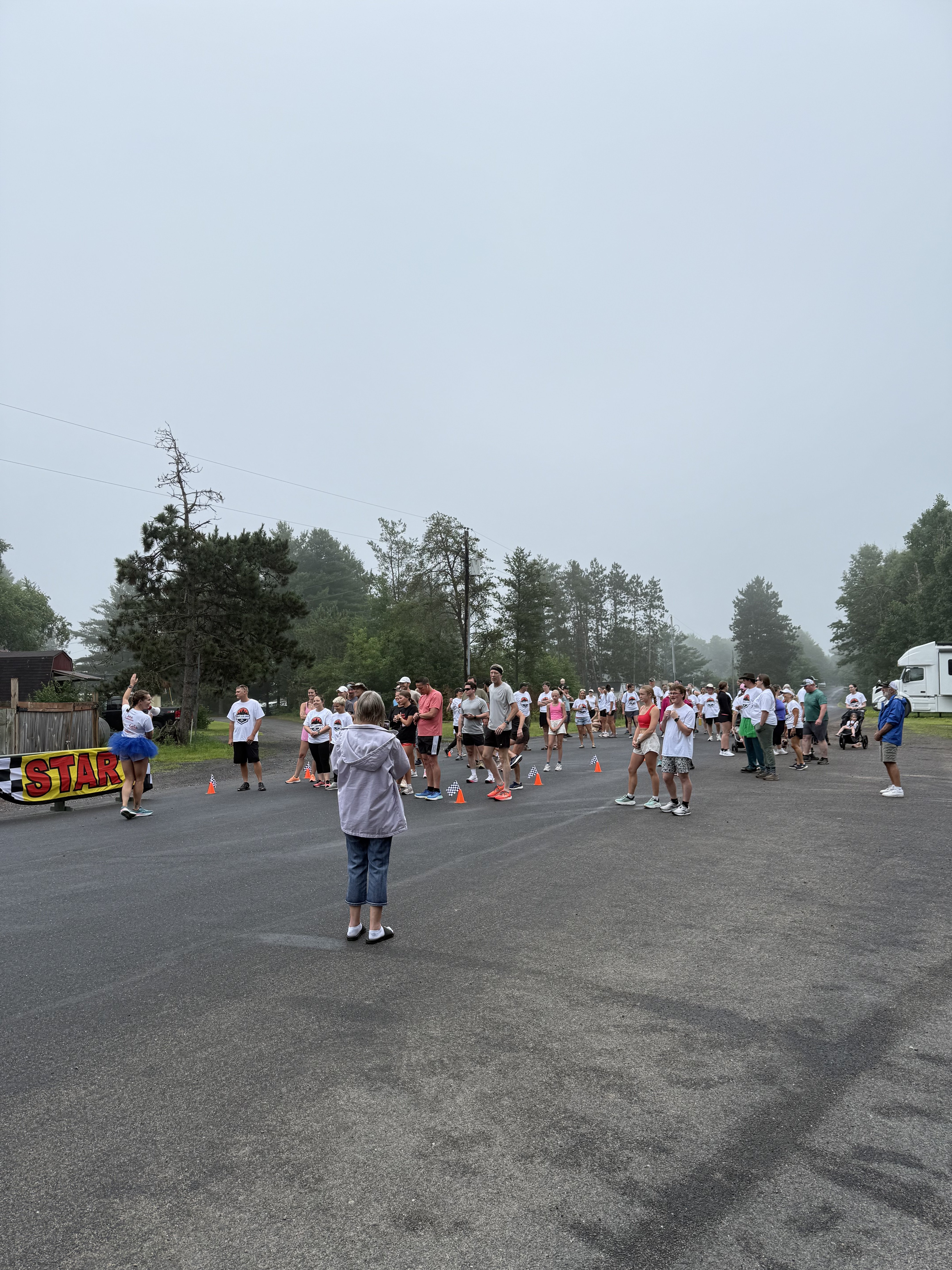 Crowd of participants lined up at the starting line with flags and START banner